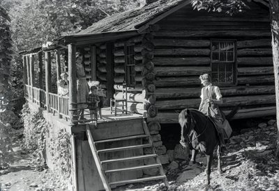 Woman, possible healthcare worker, on horseback visits with neighbors or family by Volkmar Wentzel