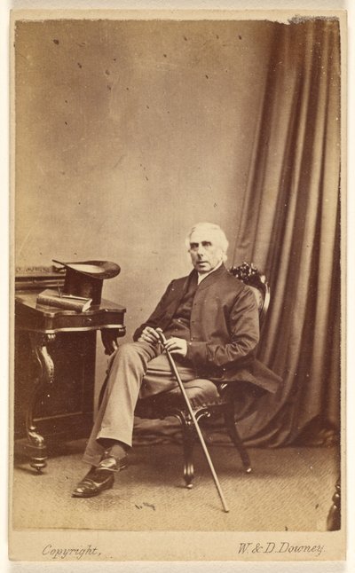 Unidentified White-Haired Man Seated, Holding a Cane, Top Hat and Book on Table at Left by W. and D. Downey