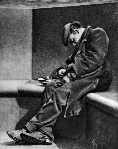 A man sleeping on Blackfriars Bridge, London, 1926-1927 by Walter Benington
