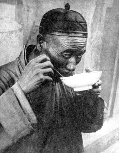 A man eating, Mukden Shenyang, China, 1936 by Wide World Photos