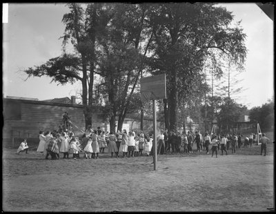 Boys and girls playing tug-o-war on an unidentified playground, c.1910 by William Davis Hassler