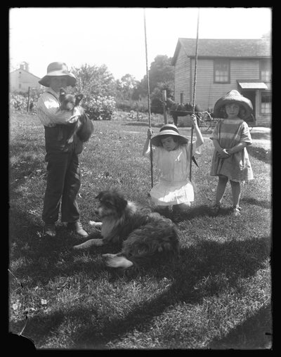 Children with a Dog and Puppy Gathered Around a Rope Swing at the McCready Farm, Pennsylvania by William Davis Hassler