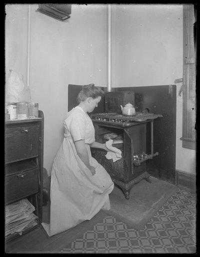 Ethel Gray Magaw Hassler taking bread from the oven by William Davis Hassler