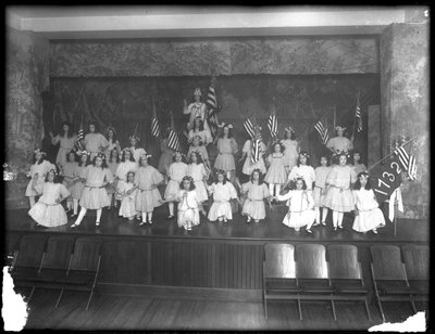Group portrait of little girls during a performance, probably the Roman Catholic Orphan Asylum, Kingsbridge, Bronx, c.1911 by William Davis Hassler