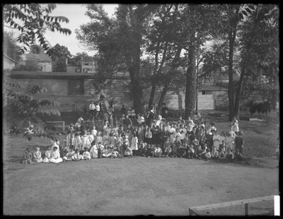 Large group of children assembled for a group portrait in an unidentified playground, c.1910 by William Davis Hassler