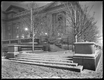 Night view of the northeast corner of the steps outside the main branch of the New York Public Library in the snow, 42nd Street and Fifth Avenue, New York City by William Davis Hassler