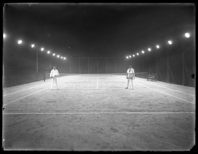 Two young men on unidentified clay tennis court at night, July 1915 by William Davis Hassler