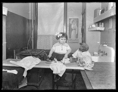 Unidentified Little Girl Demonstrating the Use of an Electric Iron by William Davis Hassler