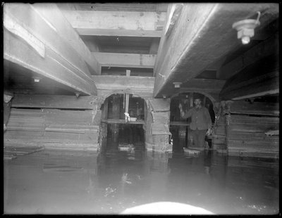 Worker inside the W. 129th Street sewer, New York, c.1911 by William Davis Hassler