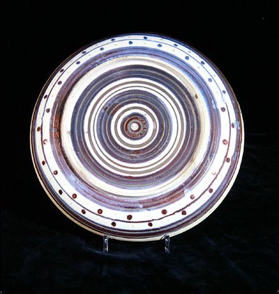 Charger with concentric circles of white, blue, purple and gold lustre by William de Morgan