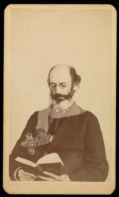 Unidentified balding, bearded man reading while seated by William H. Mumler