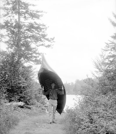 Carrying canoe in the Adirondack Mountains by William Henry Jackson