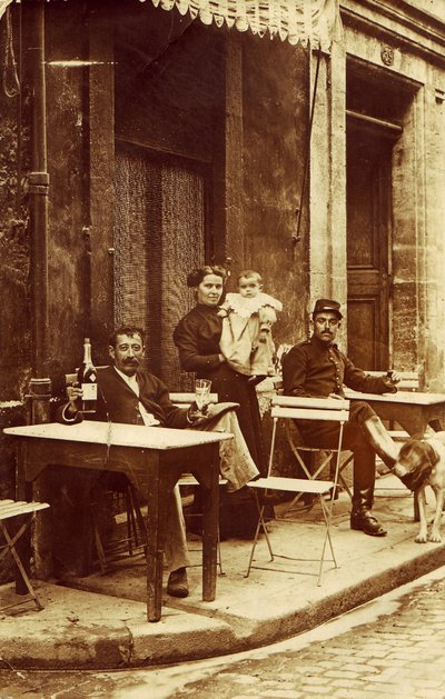 Man holding a bottle of absinthe, c 1900, on a cafe terrace by Frederick (attr. to) Barnard