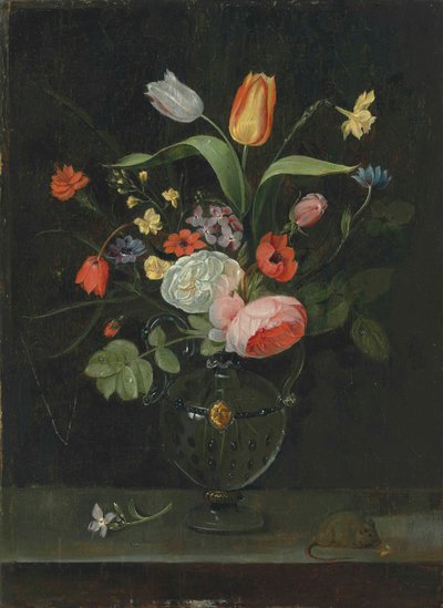 Roses, tulips, a daffodil and other flowers in a glass vase, on a stone ledge with a mouse by . .