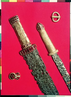 Two swords with decorated hilts and two belt buckles, from the Pouan Treasure (gold, iron und garnet) by Merovingian