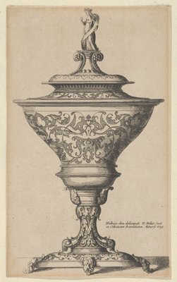 Ornate goblet on feet of masks 1645. 1645