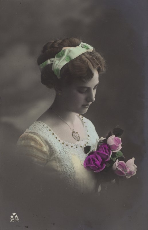 Girl peering into bunch of roses by (after) English photographer