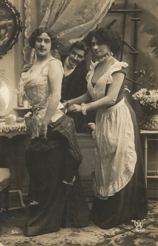 Man watching a woman dress by French Photographer