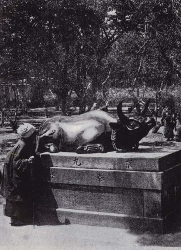 Devout woman stroking a bronze bull by American Photographer (after)