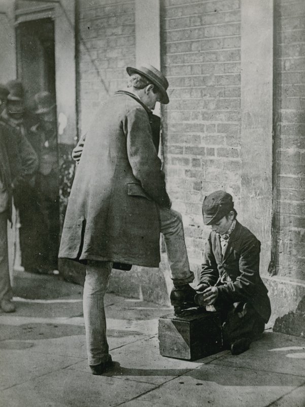 A Young Shoeblack Shining a Man
