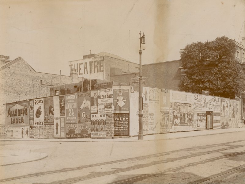 Advertisements on corner of Latchmere Road and Lavender Hill, Wandsworth, London by English Photographer