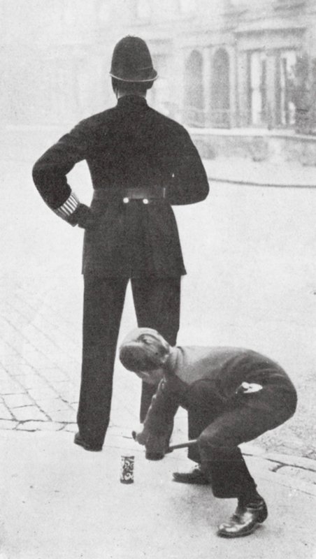 Boy Playing a Prank on a Policeman by English Photographer
