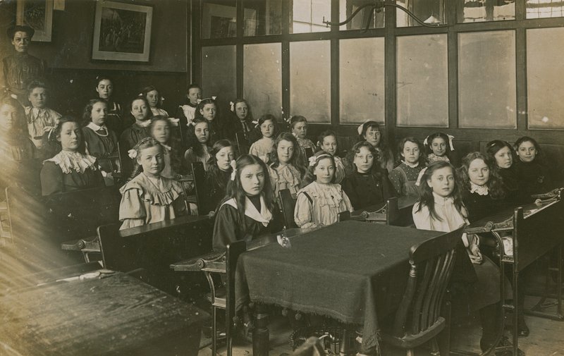 Girls Sitting in a Classroom by English Photographer