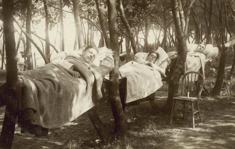 Hop pickers sleeping in hammocks on a farm in Kent by English Photographer