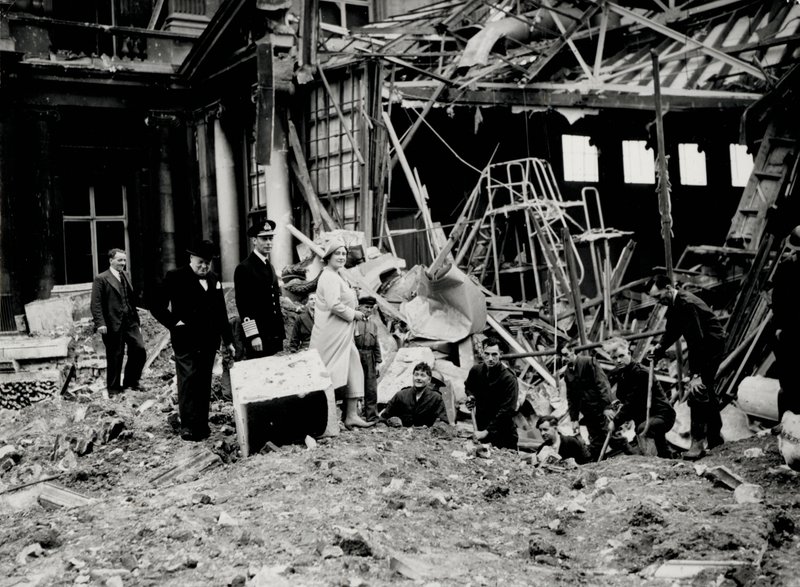 King George VI and Queen Elizabeth, together with Winston Churchill, surveying bomb damage, presumably to Buckingham Palace by English Photographer