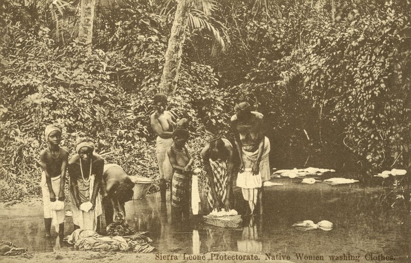 Women washing clothes in a river, Sierra Leone by English Photographer