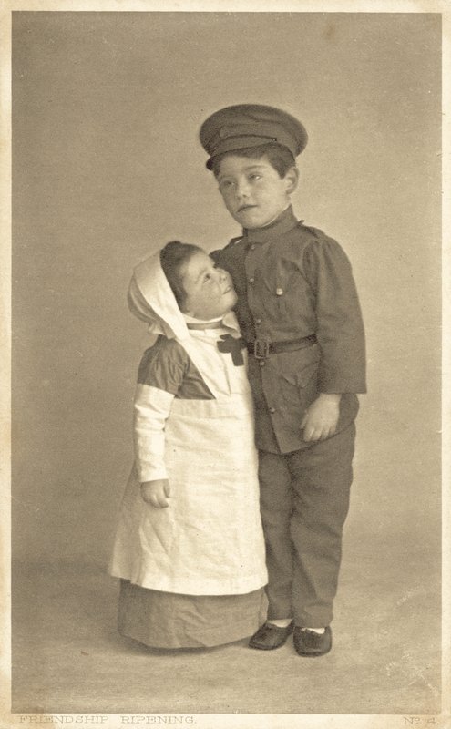 Young girl and boy in WW1 role playing by English Photographer