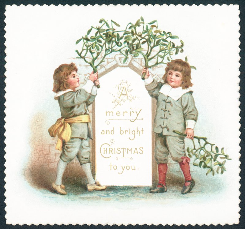 Boys hanging mistletoe to sign by English School
