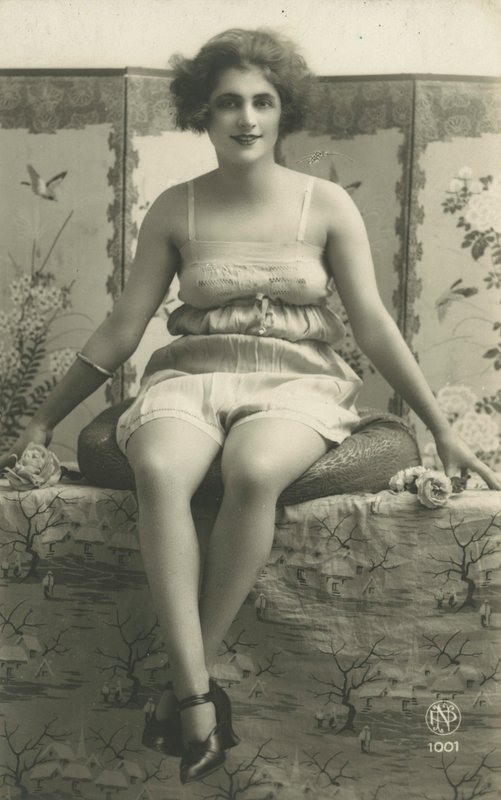 Portrait of a seated woman in her underwear by European Photographer