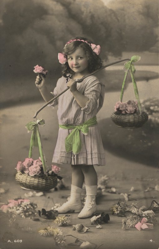 Portrait of a young girl carrying baskets of flowers by European Photographer