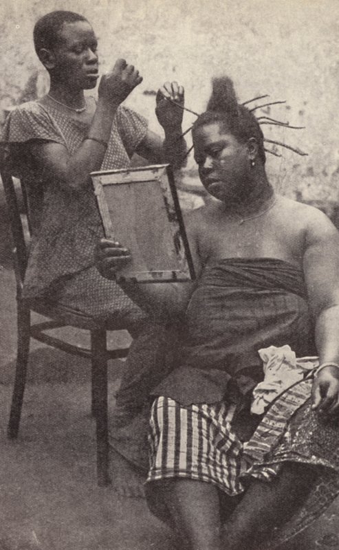 West African Woman Having Her Hair Done (b/w photo) by European Photographer
