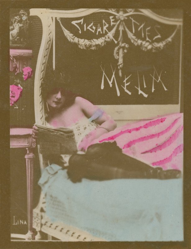 Lina, girl on bed reading newspaper by French Photographer