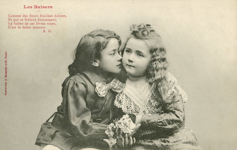 Little boy kissing a little girl by French Photographer