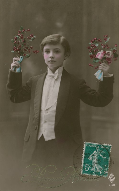 Postcard of a boy in white tie and tails holding flowers and berries, sent in 1913 by French Photographer
