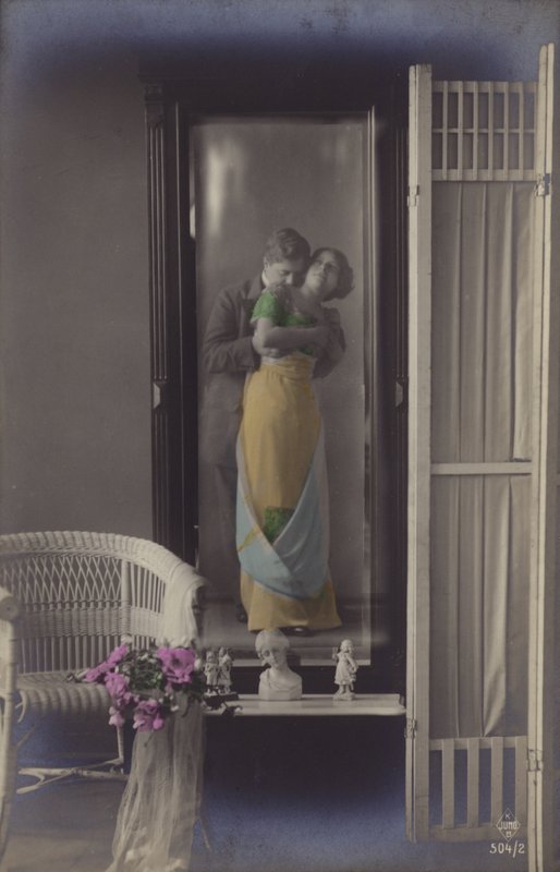 The Reflection in a Mirror of a Young Couple Kissing by French Photographer