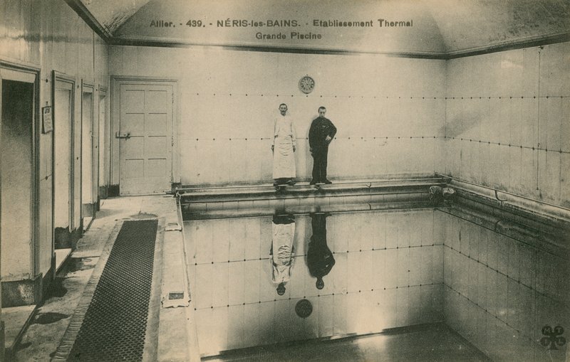 Two men standing in the thermal baths at Neris les Bains in France by French Photographer