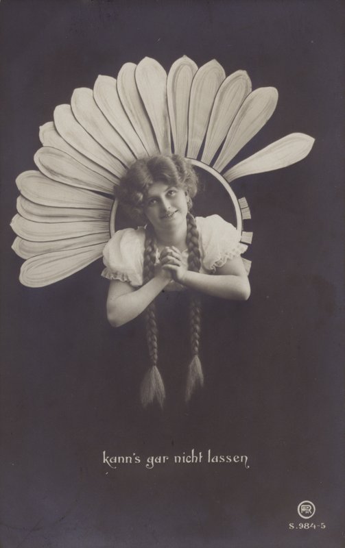 A young woman with long plaits sticks her head through a flower by German School