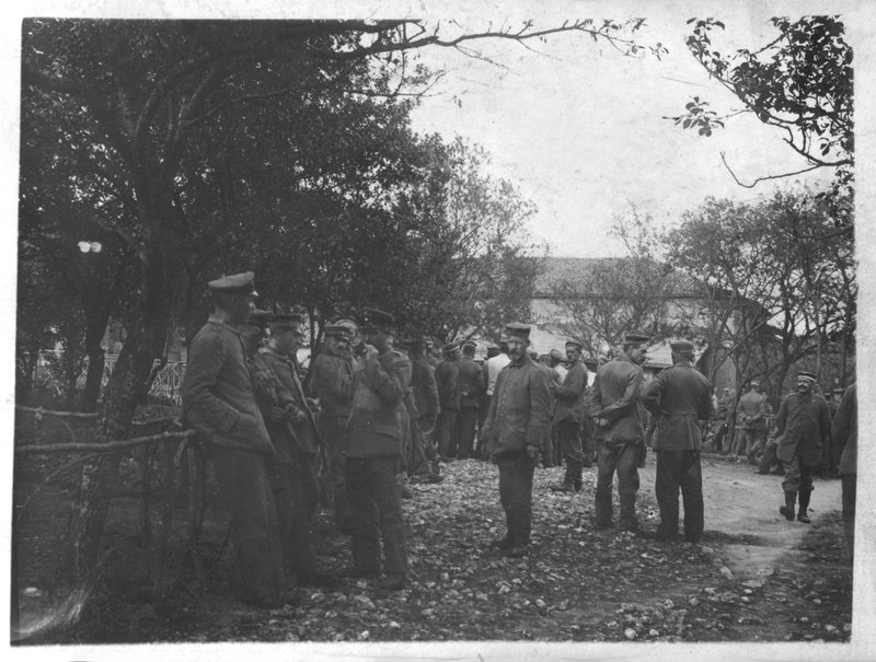 German soldiers in a village or town square by Photographer German
