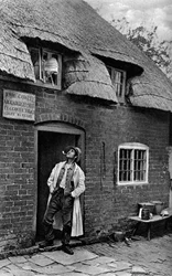 A Man Smoking a Pipe Outside a Shop, Worcestershire