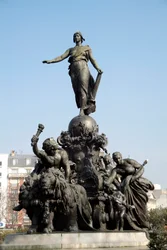 The Chariot of the Nation or Triumph of the Republic. Symbol of universal suffrage. Standing on a chariot drawn by two lions (symbol of popular force), Marianne is surrounded by the allegories of Labour, Justice, Peace and Abundance. Around her, the