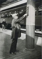 A conductor signalling the imminent departure of the 