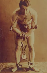 Harry Houdini in chains, c.1899