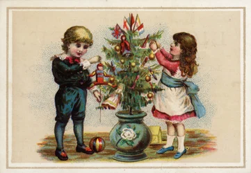 Children decorating a small Christmas tree