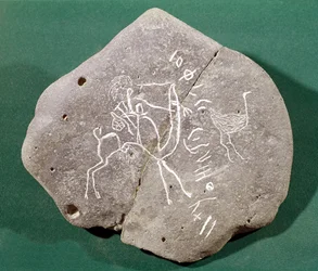 Stone inscribed with a hunter in the desert and a safaitic inscription