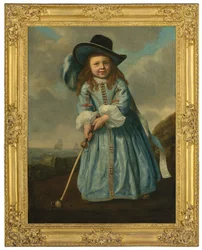 Portrait of a boy playing golf by the shore