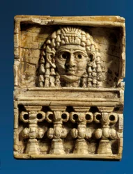 Plaque depicting a woman at a window